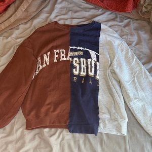 A multi clothed crewneck from urban outfitters, size medium but fits a small